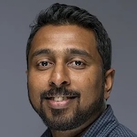 Headshot of Nishad Jayasundara, wearing a blue-gray collared shirt and softly smiling into camera. Jayasundara is the Juli Plant Grainger Assistant Professor of Global Environmental Health at the Nicholas School of the Environment.