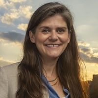 Sara Oliver, director of the Master of Engineering in Climate and Sustainability Engineering, photographed beside solar panels on the Bryan Center rooftop. Oliver is passionate about empowering engineering leaders of the future with the technical knowledge and skills needed to innovate and design solutions to climate challenges within our uncertain and rapidly changing world. Through her career working on large scale infrastructure projects and in partnership with communities who are impacted both by those infrastructure projects and climate change – she has a unique perspective on the increasing demand for engineers equipped to synthesize the big picture of the climate landscape with the technical skills expertise required to implement engineering solutions.